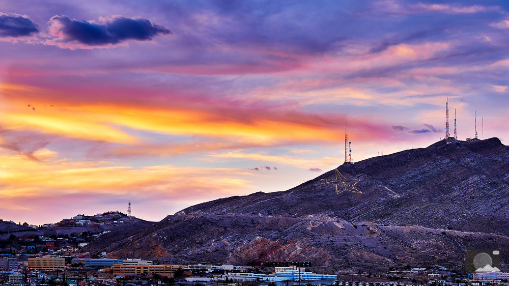 El Paso skyline at sunset with the Star on the Mountain lit above the city
